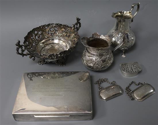 A Victorian silver cream jug, an Indian jug, two wine labels, a German cigarette box and a small silver bowl.